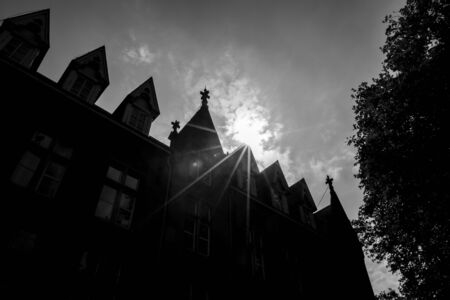 Black and white high contrast street view of beautiful historic city center architecture of Bruges or Brugge, West Flanders province, Belgium. Lovely summer August weather. Sun diffractionの写真素材