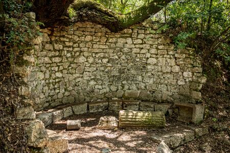 Place to rest and reflect. Beautiful warm spring day and archeological ruins at Butrint National Park, Albania, UNESCO heritage. Travel photography with fresh green flora and clear blue skyの写真素材