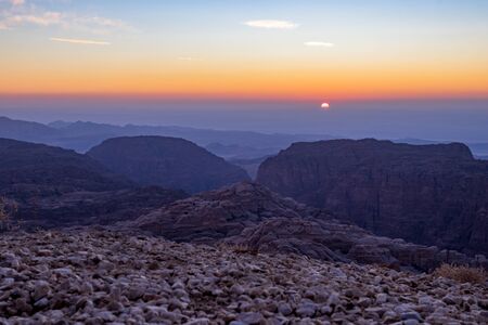Beautiful scenery landscape. Mountain view at sunset over the desert mountains at Wadi Musa, Hashemite Kingdom of Jordan. The edge between the golden and blue hoursの写真素材
