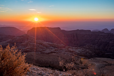 Beautiful scenery landscape. Mountain view at sunset over the desert mountains at Wadi Musa, Hashemite Kingdom of Jordan. The edge between the golden and blue hoursの写真素材