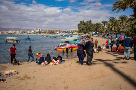 AQABA, JORDAN - JANUARY 31, 2020: Local people and tourists enjoy holiday Friday at sunny city beach...