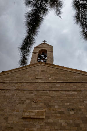 Front wall with bell tower, Greek orthodox basilica of Saint George, Madaba city in Middle East country Kingdom of Jordan.の写真素材