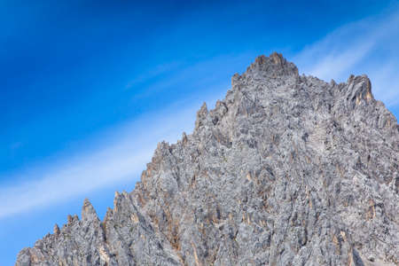 Gray rock formation with blue sky and cloudsの写真素材