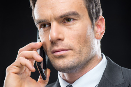 Close-up portrait of handsome businessman talking on smartphone Close-up portrait of handsome businessman talking on smartphone