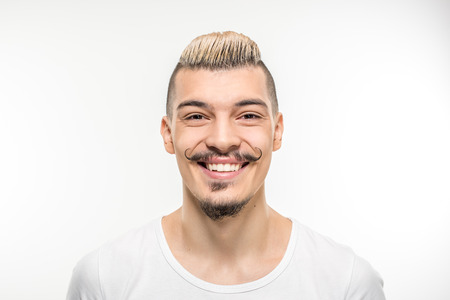 Portrait of smiling young man looking at the camera on whiteの写真素材