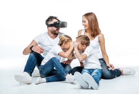 Man in virtual reality headset with familyの写真素材