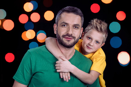 Portrait of smiling father and son looking at cameraの写真素材