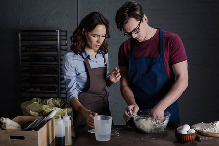 Bakers discussing ingredientsの写真素材