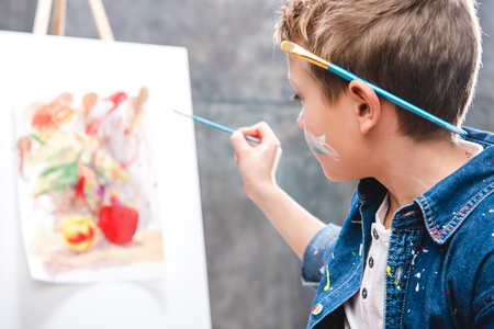 Little male artist painting pictureの写真素材