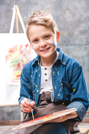Little male artist painting pictureの写真素材