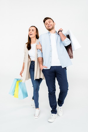 couple walking with shopping bags on whiteの写真素材