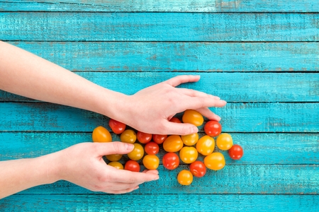 hands holding cherry-tomatoesの写真素材