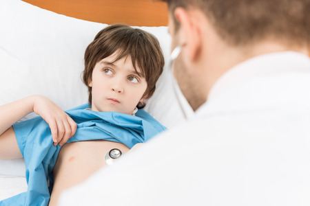 doctor examining pensive little boyの写真素材