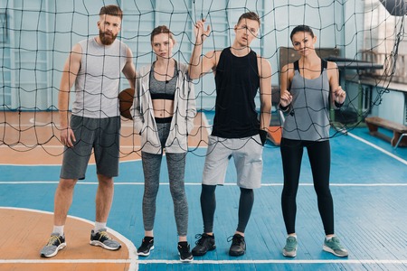 sportsmen and sportswomen looking through net