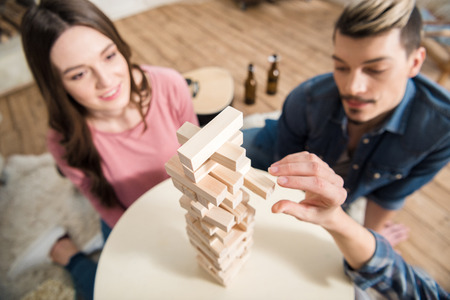 friends playing jenga game at homeの写真素材