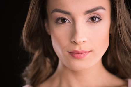 portrait of beautiful young brunette woman looking at cameraの写真素材
