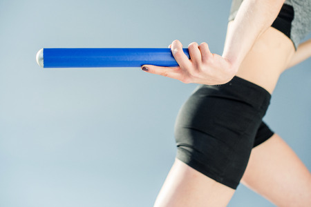 partial view of sportswoman running in relay raceの写真素材