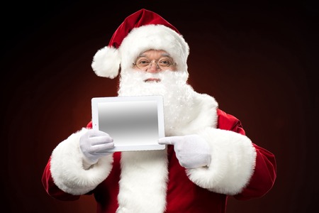 Santa Claus with digital tabletの写真素材