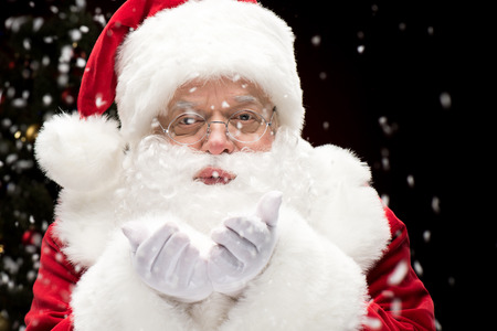 Santa Claus blowing snowflakesの写真素材