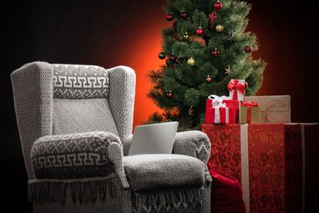 Armchair with gift boxes and fir-treeの写真素材