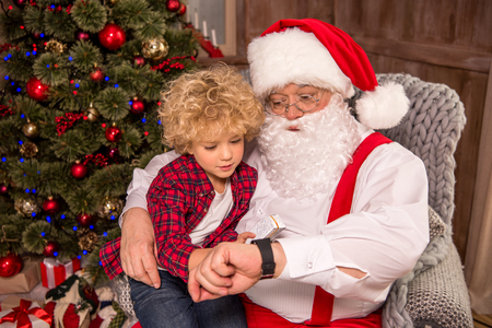Santa Claus with kid on kneeの写真素材