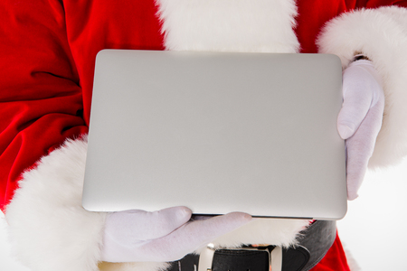 Santa Claus hand showing laptopの写真素材