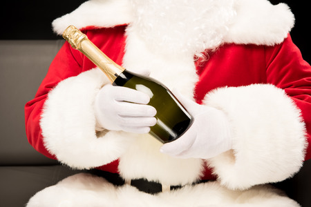 Santa Claus holding bottle of champagneの写真素材