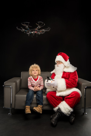 Santa Claus using hexacopter drone with childの写真素材