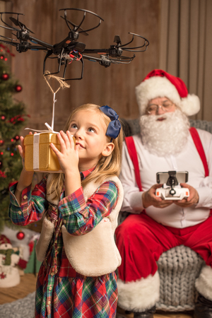 Santa with kid using hexacopter droneの写真素材