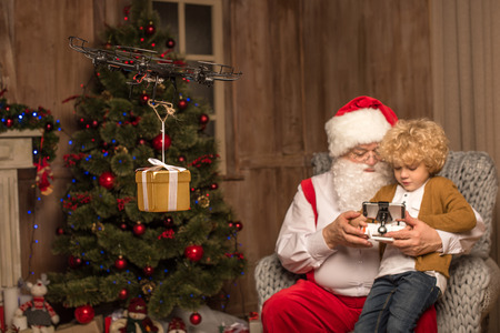 Santa with kid using hexacopter droneの写真素材