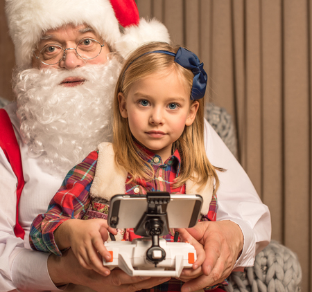 Santa Claus with kid looking at cameraの写真素材