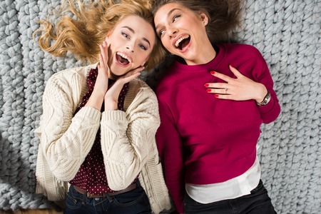 Women lying on grey carpetの写真素材