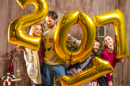 Happy people with golden balloons