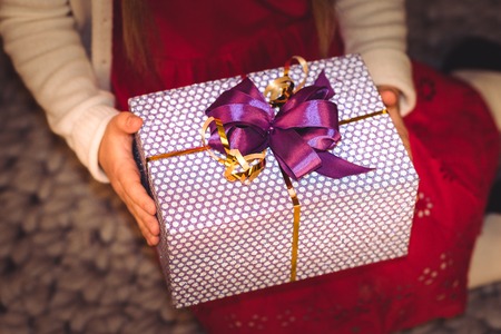Partial view of girl holding gift boxの写真素材