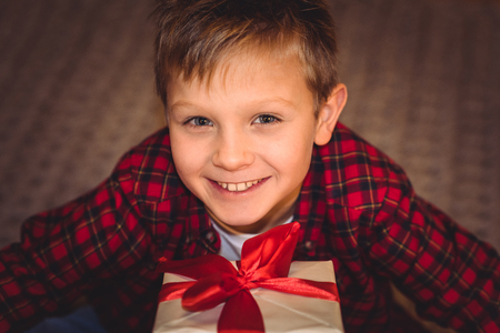 Boy holding gift boxの写真素材
