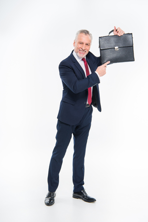 Businessman pointing at briefcaseの写真素材