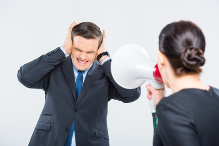 Businesswoman screaming at businessmanの写真素材