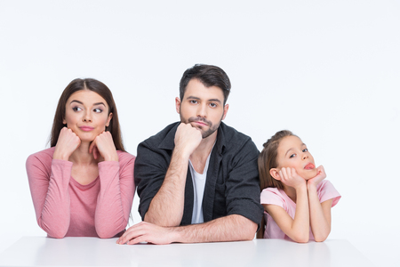young family with one child looking at camera on whiteの写真素材