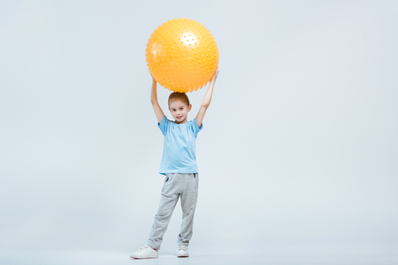 sporty girl holding fitness ball on whiteの写真素材
