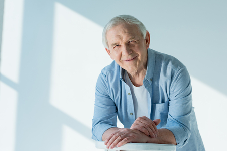 portrait of smiling senior man in casual shirtの写真素材