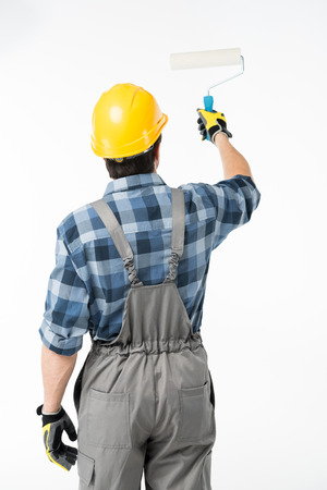 Workman with paint rollerの写真素材
