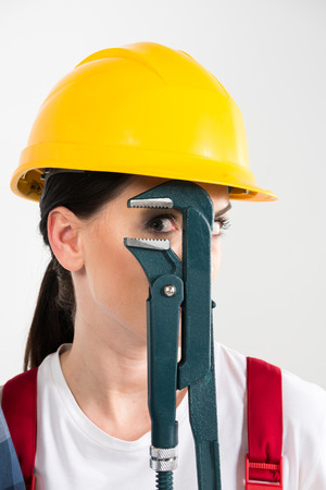 Female builder holding wrenchの写真素材