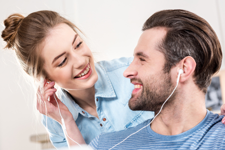 Smiling couple with earphonesの写真素材