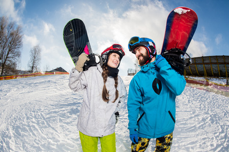 Man and woman with snowboardsの写真素材