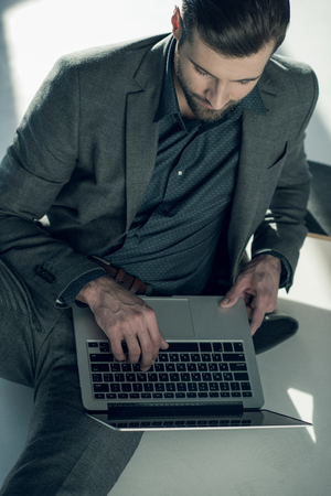 man typing on laptopの写真素材