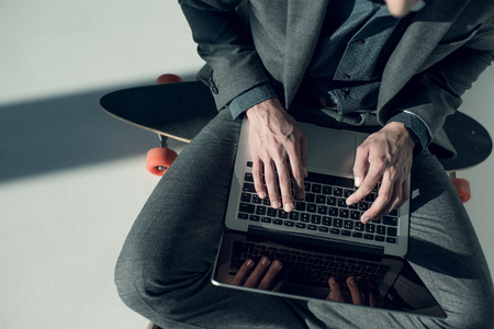 man typing on laptopの写真素材