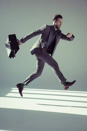 Handsome businessman with briefcaseの写真素材