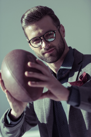 Stylish man with rugby ballの写真素材