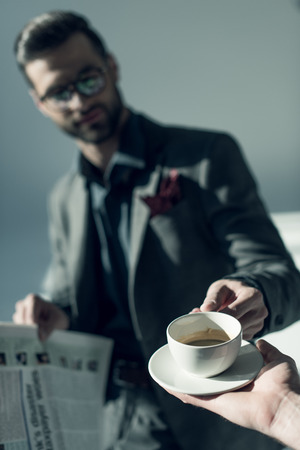 Handsome man with newspaperの写真素材