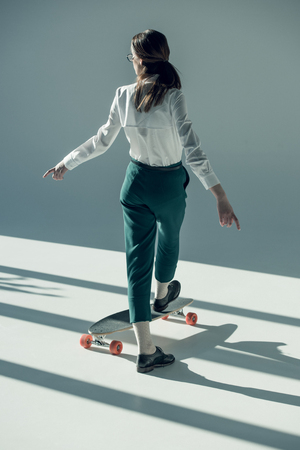 woman standing on skateboardの写真素材